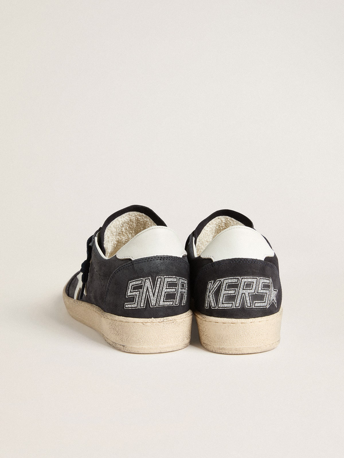 Dark blue suede with a star and a leather heel tab
