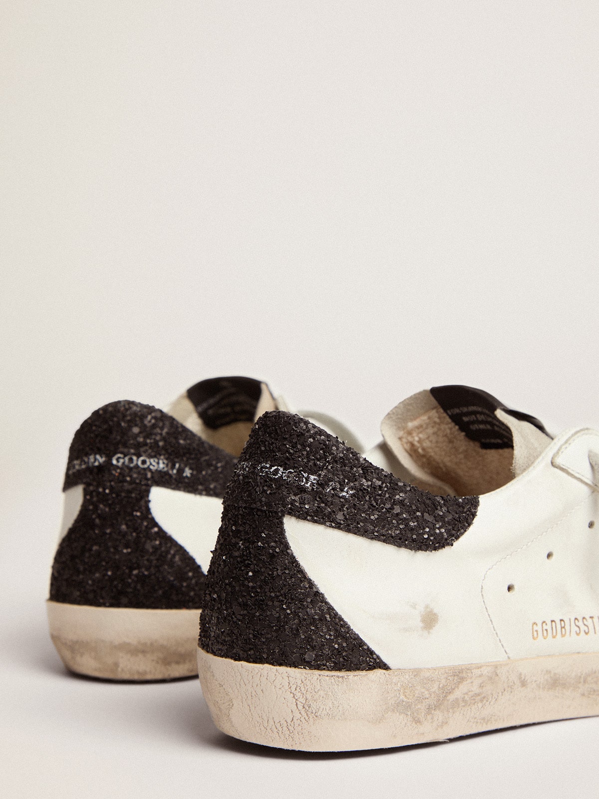 Super Star LTD with gold star appliqué and black glitter heel detail