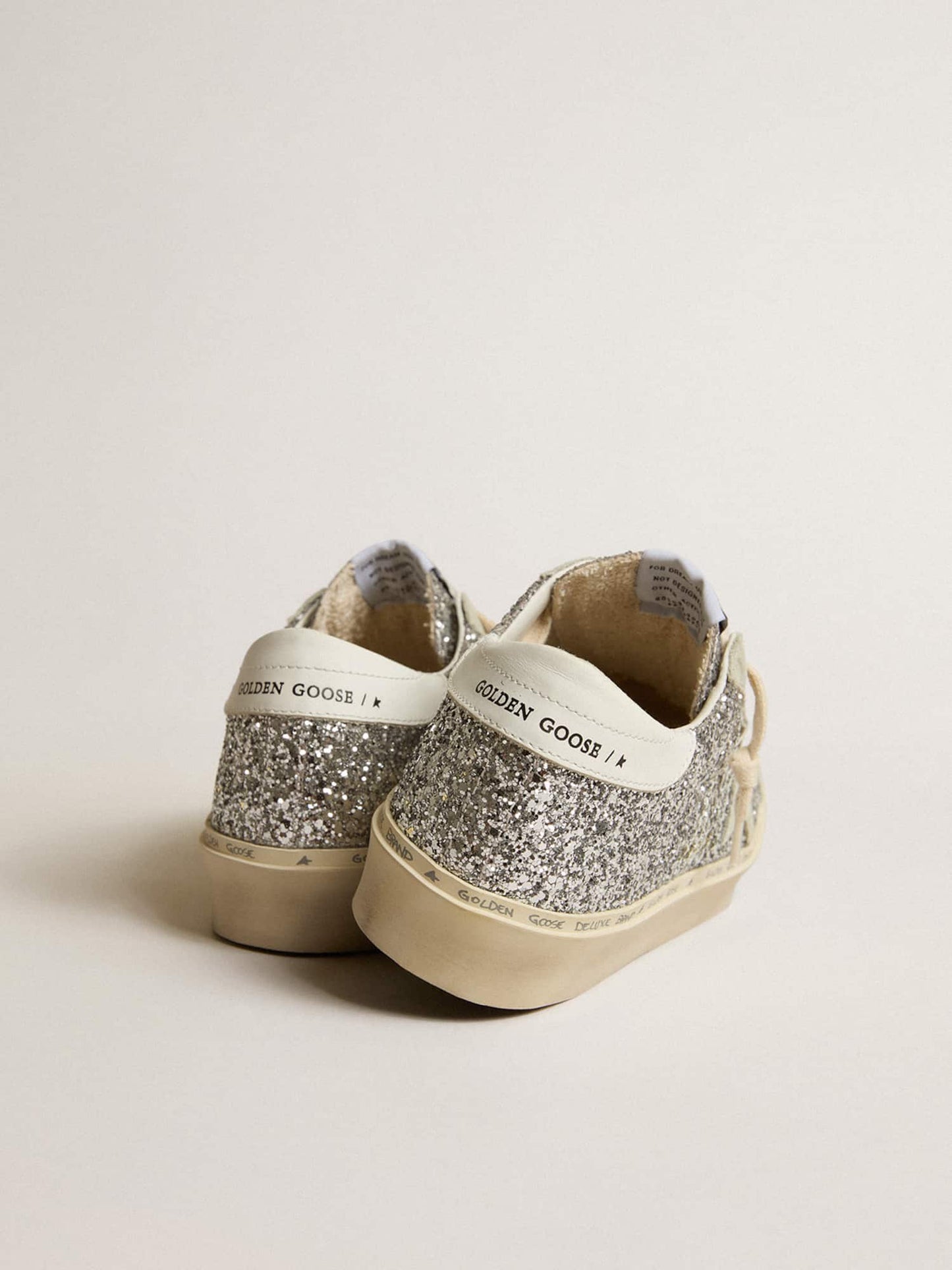 Silver glitter with a suede star and a white heel tab