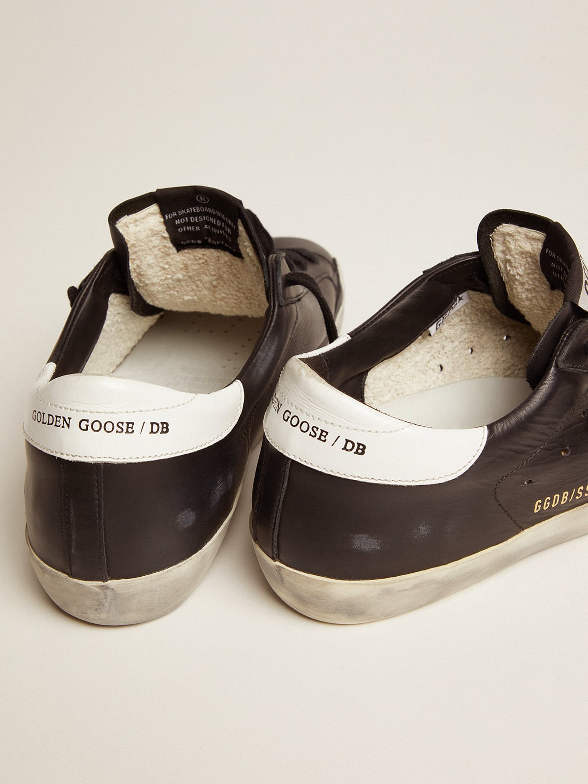 Black leather with a star and a white leather heel tab