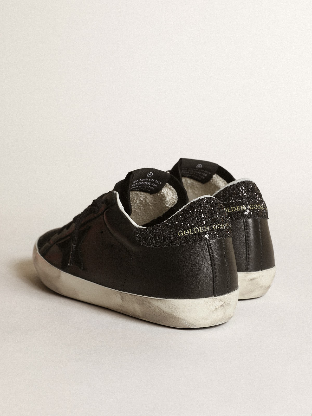 Black nappa leather with a black suede star and a black glitter heel