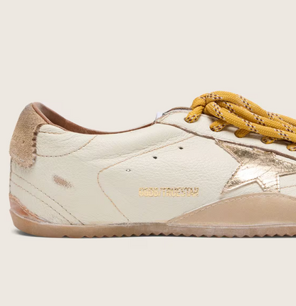 White nappa leather with a gold star and a beige suede heel tab