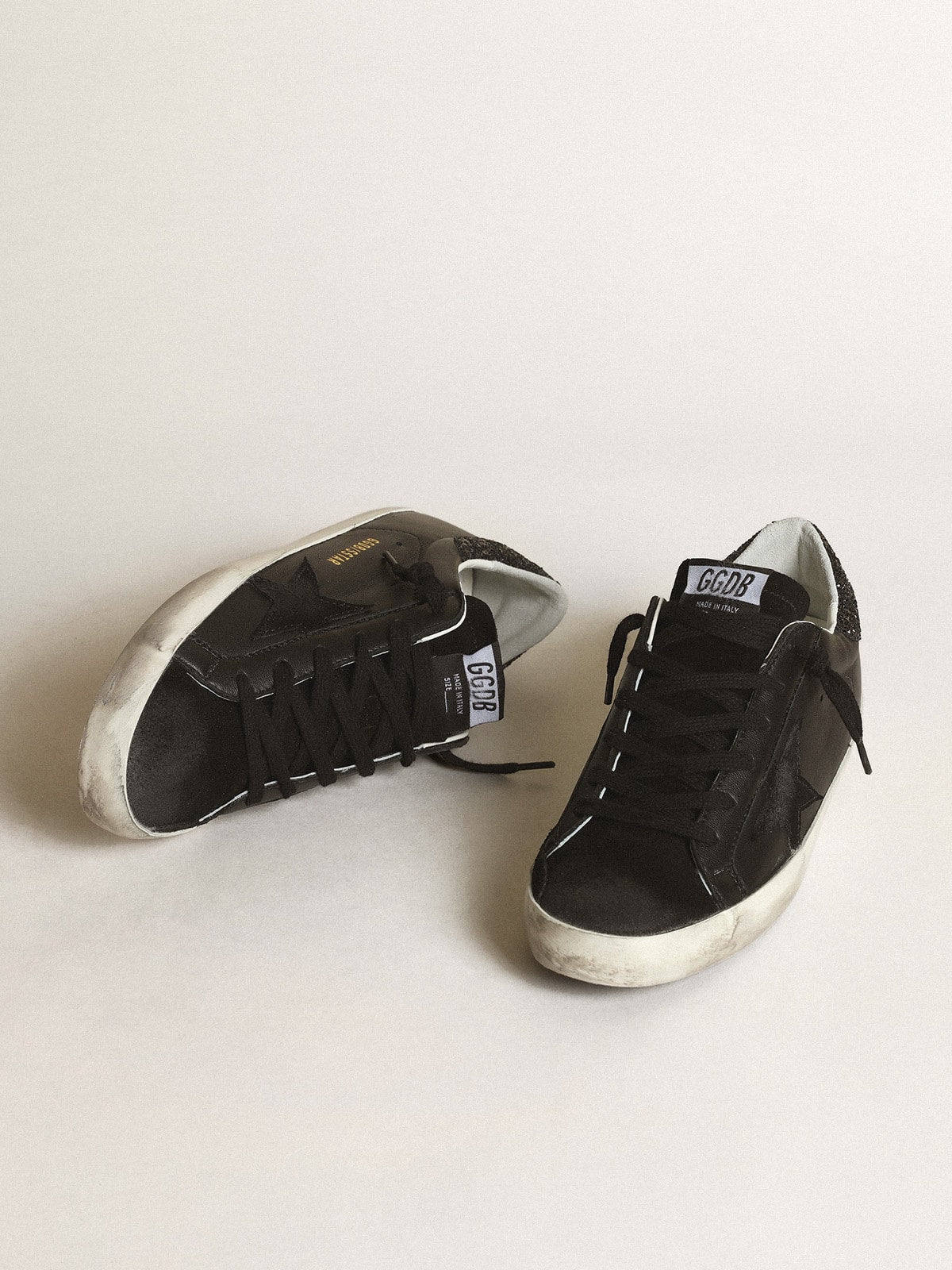 Black nappa leather with a black suede star and a black glitter heel